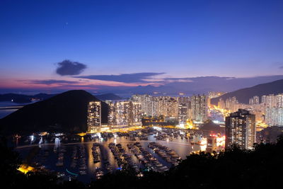 High angle view of city lit up at night