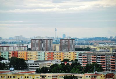 Buildings against cloudy sky