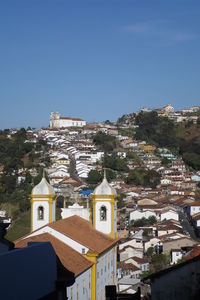 High angle view of buildings in city against clear sky