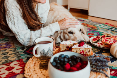 Man with dog on table at home