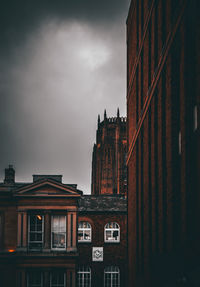 Low angle view of liverpool cathedral with other buildings in foreground