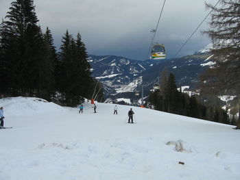 People walking on snowcapped mountain