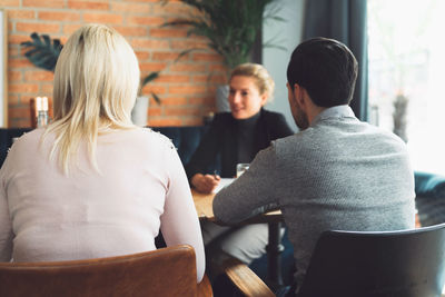 Rear view of woman sitting at restaurant