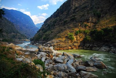 Scenic view of river flowing through rocks