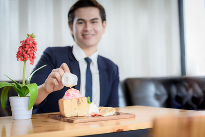 Young man sitting on table