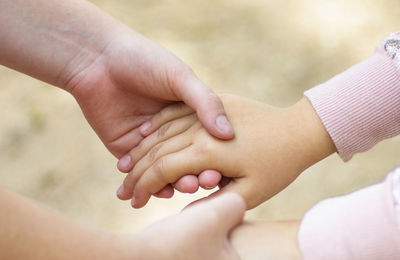 Close-up of children holding hands