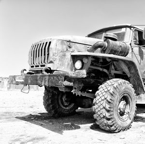 Old rusty car against clear sky