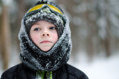 Close-up of boy during snowfall