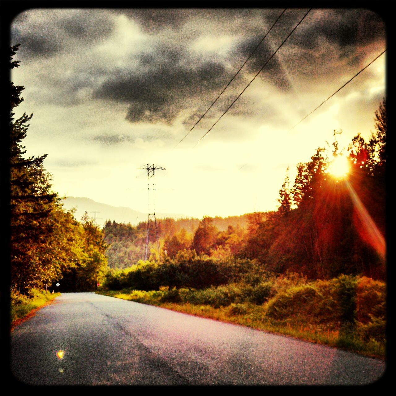 sky, transportation, cloud - sky, road, transfer print, tree, the way forward, sun, auto post production filter, cloudy, sunbeam, sunlight, sunset, diminishing perspective, nature, scenics, tranquility, beauty in nature, country road, tranquil scene