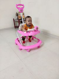 Cute girl looking away while sitting on floor