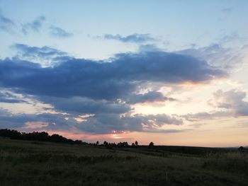 Scenic view of field against sky during sunset