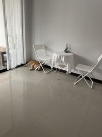 Empty chairs and table against wall at home