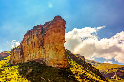 Low angle view of rock formation against sky