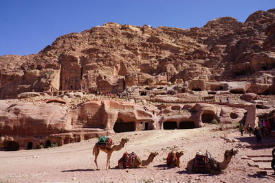 Tourists at old ruins against sky