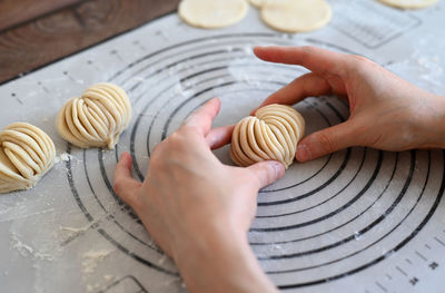 Cropped hand of woman holding food on table