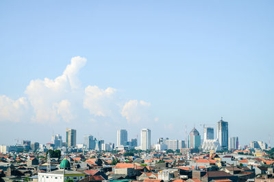 Buildings in city against sky