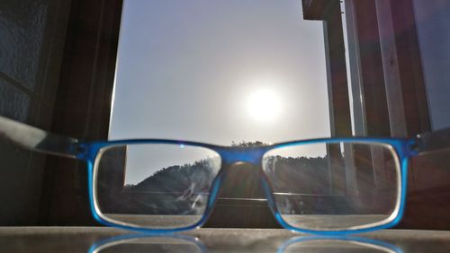 Close-up of sunglasses against sky