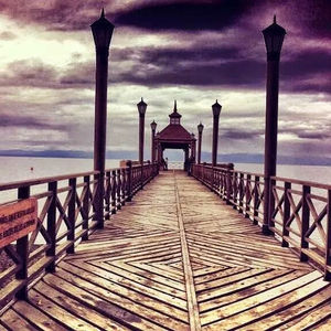 View of pier over sea against cloudy sky