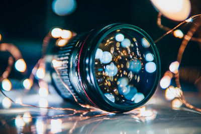 Close-up of hand holding illuminated glass