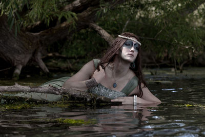 Portrait of beautiful young woman in water