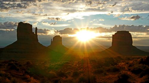 Scenic view of landscape against cloudy sky