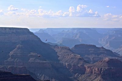 Scenic view of mountains and valley and grand canyon against sky