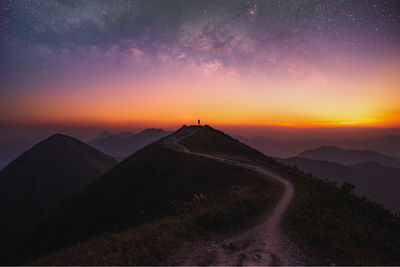 Scenic view of mountains against sky at night