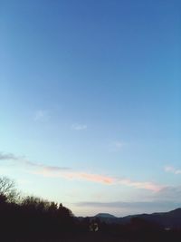 Scenic view of silhouette mountains against sky at sunset