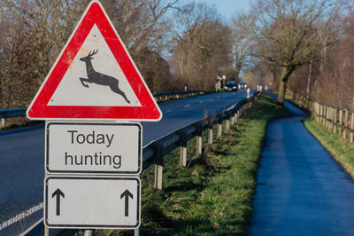 Close-up of road sign against trees