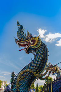 Low angle view of statue of temple against sky