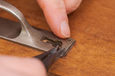 Close-up of hand holding wood