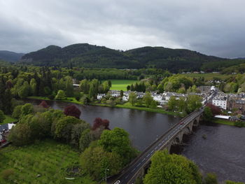 High angle view of river amidst trees against sky