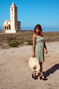 Portrait of young woman standing outdoors
