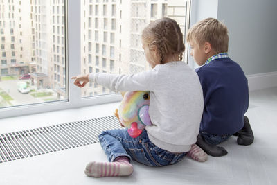 Boy with toy against window