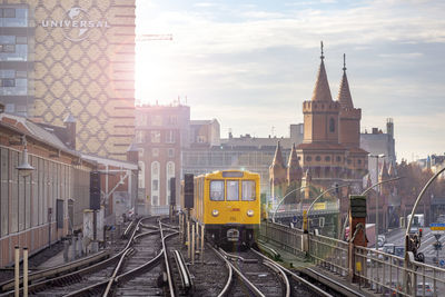 Train passing through buildings in city