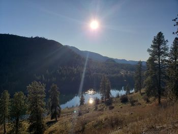 Scenic view of mountains against bright sun