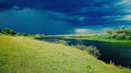 Scenic view of lake against cloudy sky