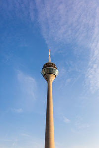 Low angle view of communications tower against sky