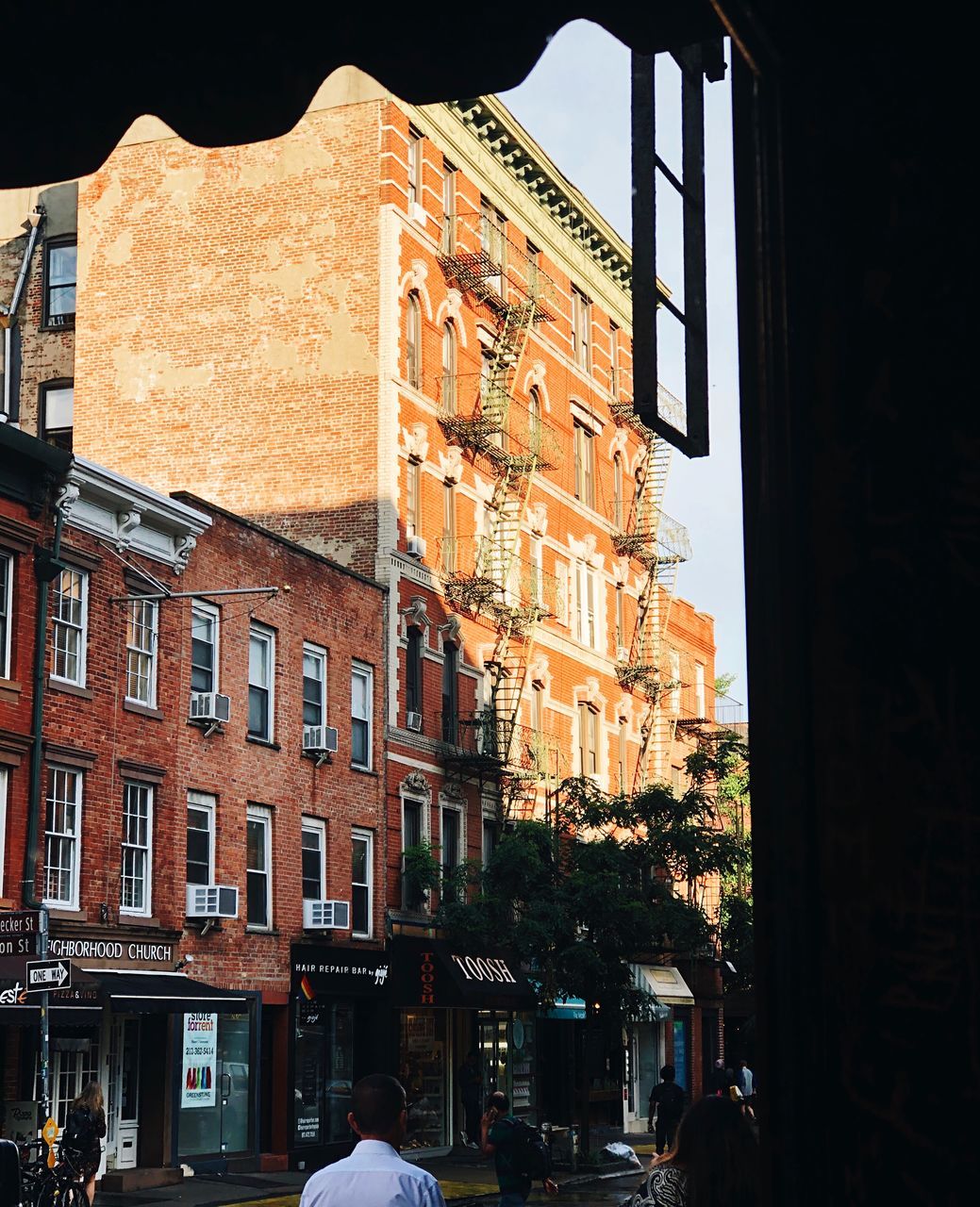 built structure, architecture, building exterior, building, city, window, residential district, nature, outdoors, day, motor vehicle, mode of transportation, sky, incidental people, car, land vehicle, travel destinations, street, sunlight, apartment