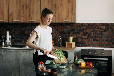 Sports woman cooking healthy eat at home