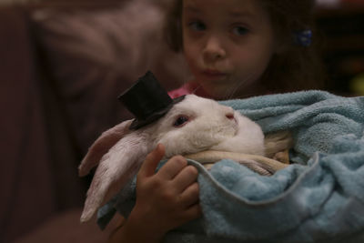 Portrait of girl with rabbit at home