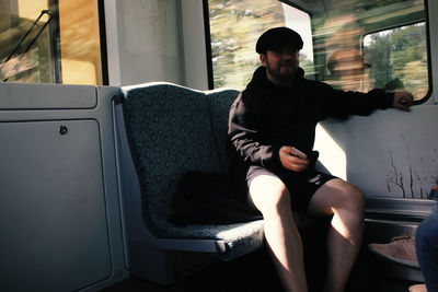 Full length of man sitting in bus