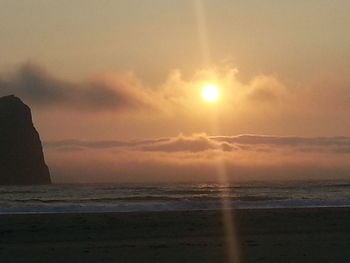 Scenic view of beach against sky during sunset