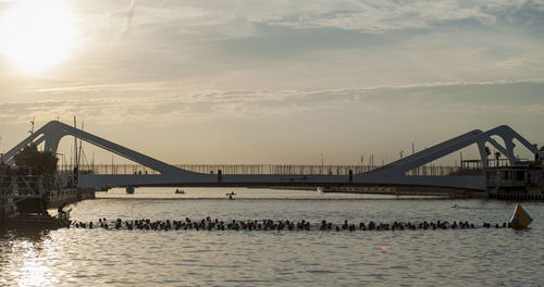 Bridge over river at sunset