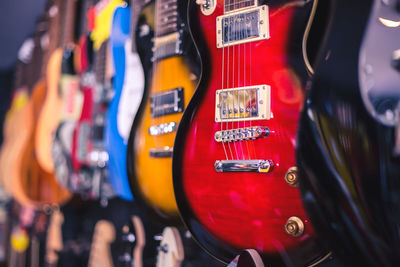 Close-up of various guitars for sale