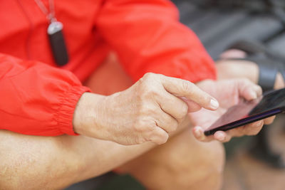 Midsection of man using mobile phone