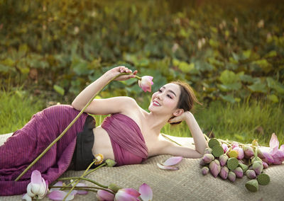 Young woman lying on plant