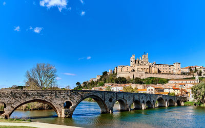 Pont vieux over orb river against beziers cathedral on sunny day