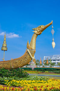 Low angle view of statue against blue sky