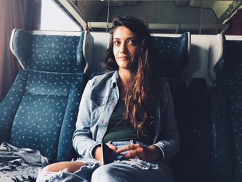 Portrait of woman sitting in train